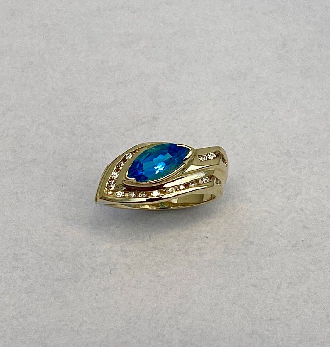 Marquise-Cut Yellow Gold Blue Topaz ring accented with Full-Cut Round Diamonds
